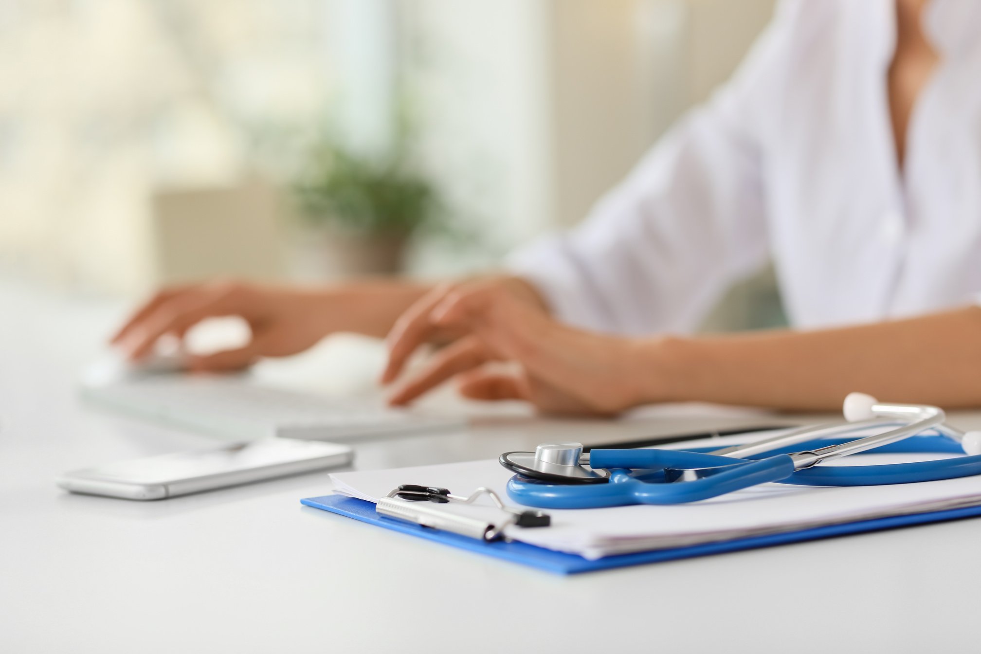 Clipboard and Stethoscope on a Table in a Clinic